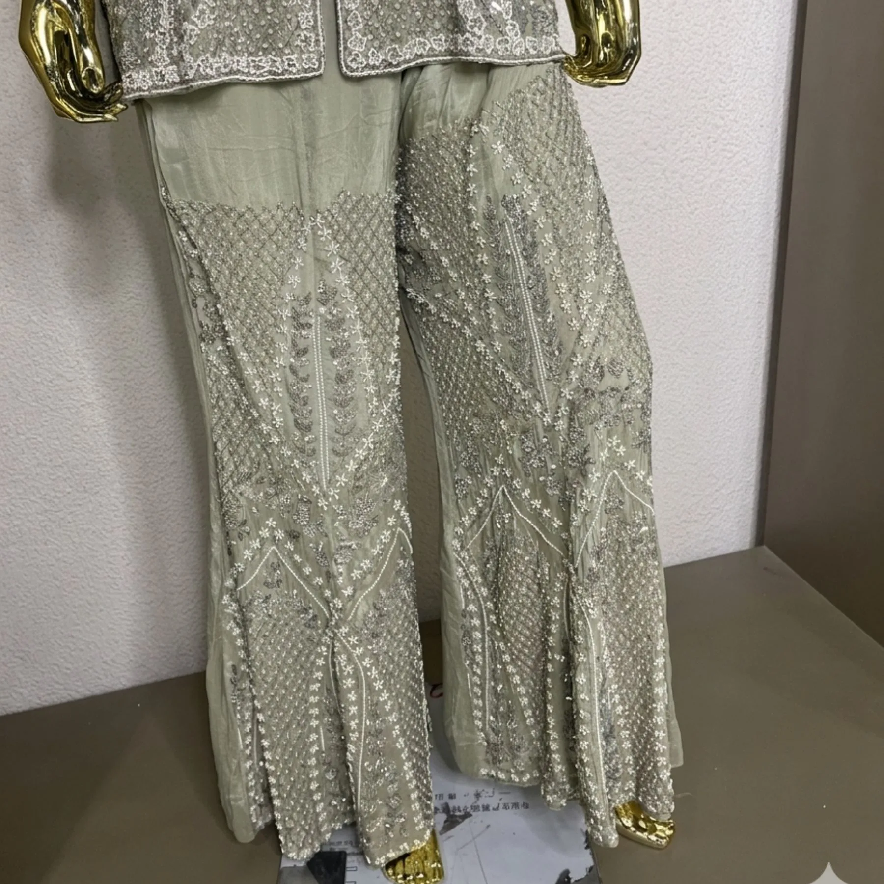 Woman wearing sage green organza pearl work co-ord set with dupatta