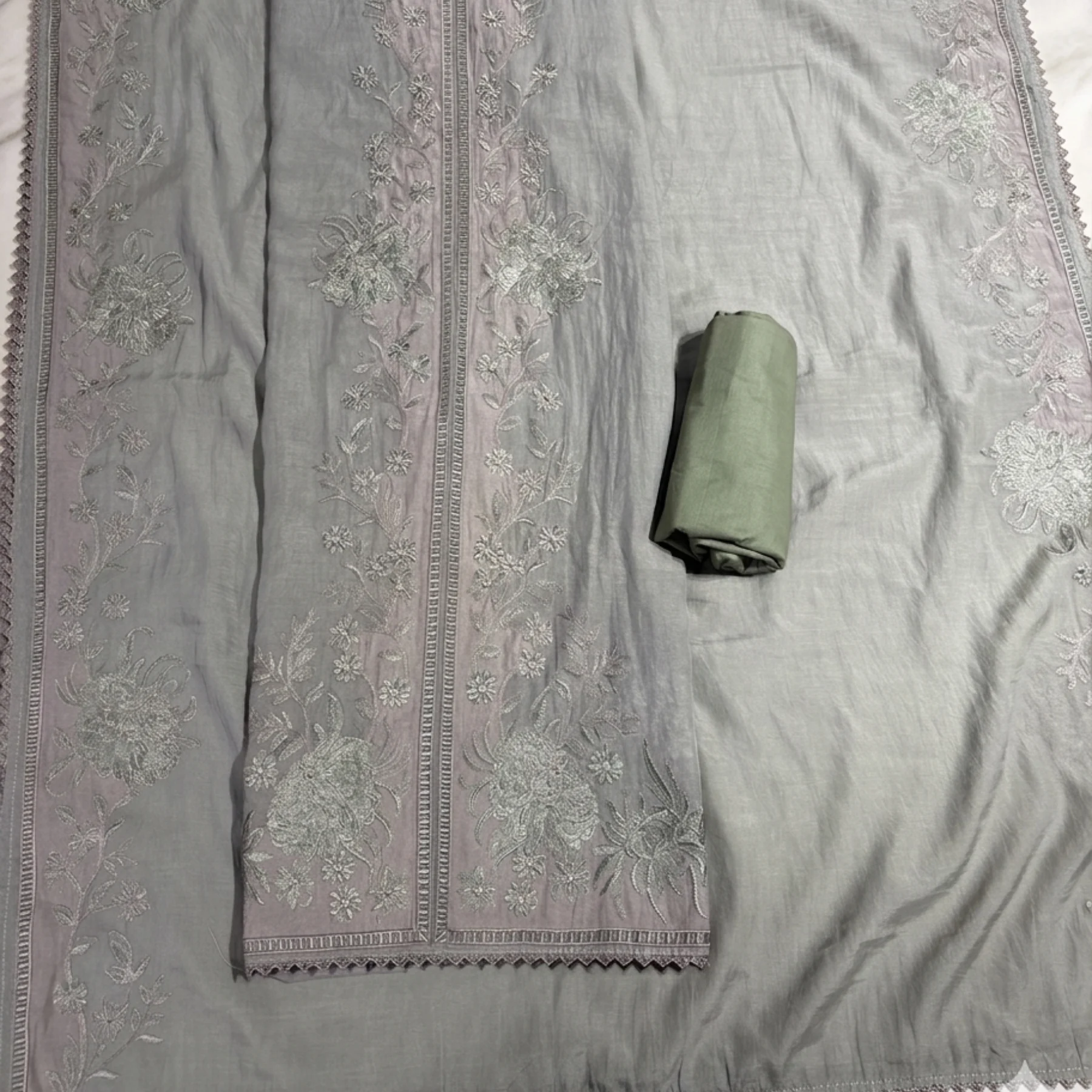 Soft gray mul cotton unstitched suit with sage green bottom and mint gray thread work by Kharatis