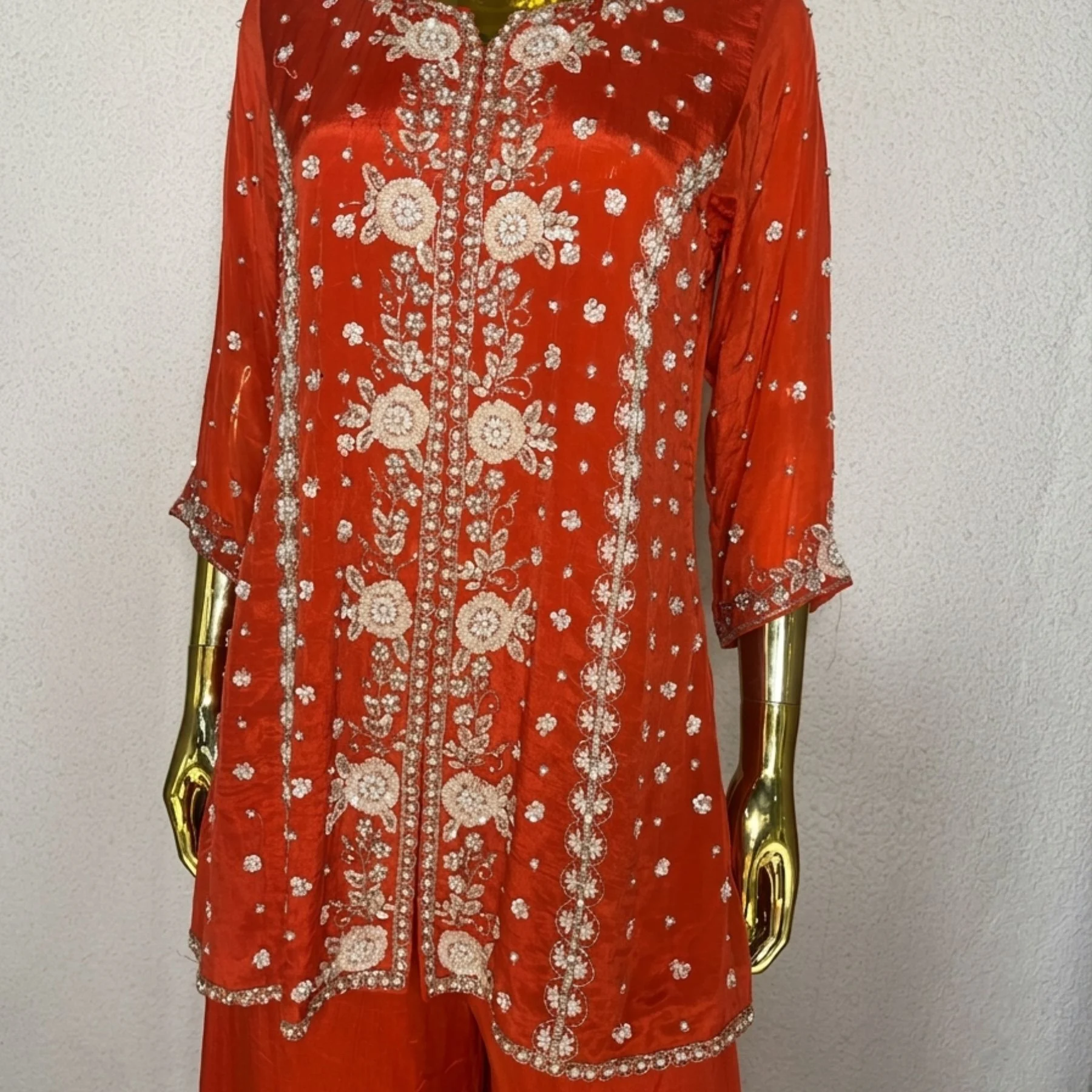 Woman wearing orange chinnon pearl work embroidered co-ord set