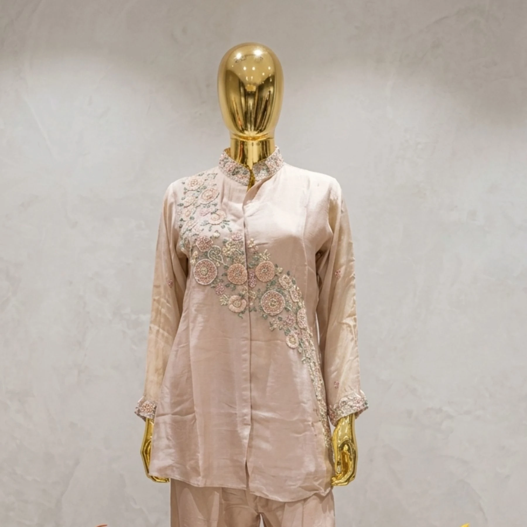 Woman wearing blush pink organza embroidered co-ord set with pearl work