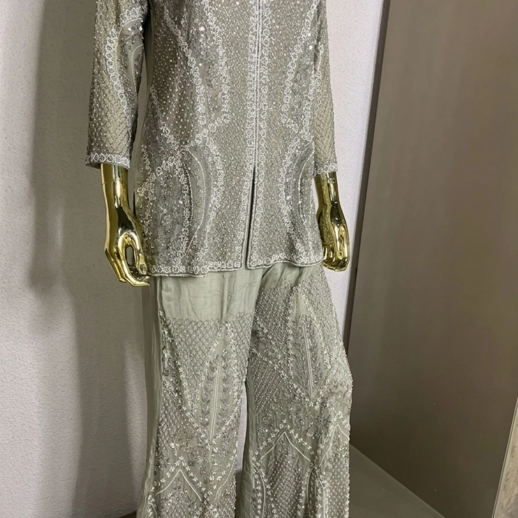 Woman wearing sage green organza pearl work co-ord set with dupatta
