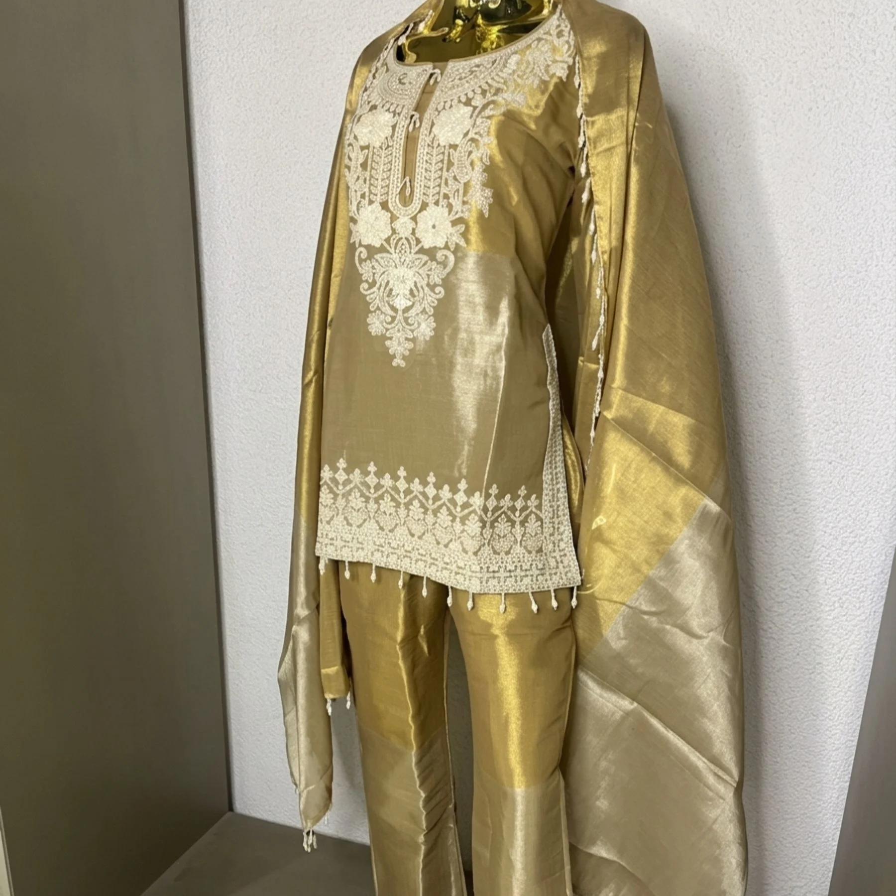 Woman wearing gold shimmer pearl work bell bottom co-ord set with dupatta