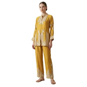 Woman wearing mustard chinnon co-ord set with thread work