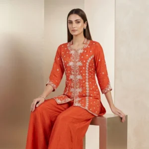 Woman wearing orange chinnon pearl work embroidered co-ord set