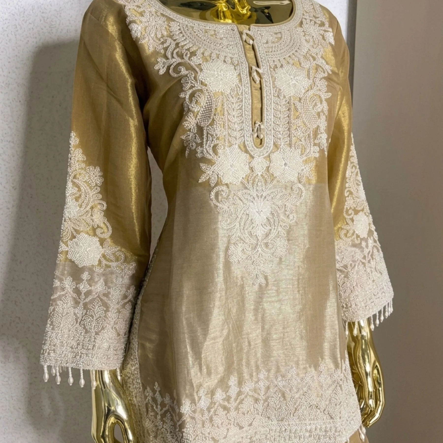 Woman wearing gold shimmer pearl work bell bottom co-ord set with dupatta