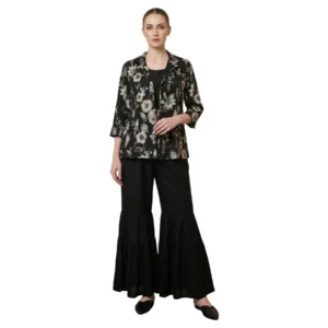 Woman wearing black printed chinnon garara co-ord set with pearl work jacket