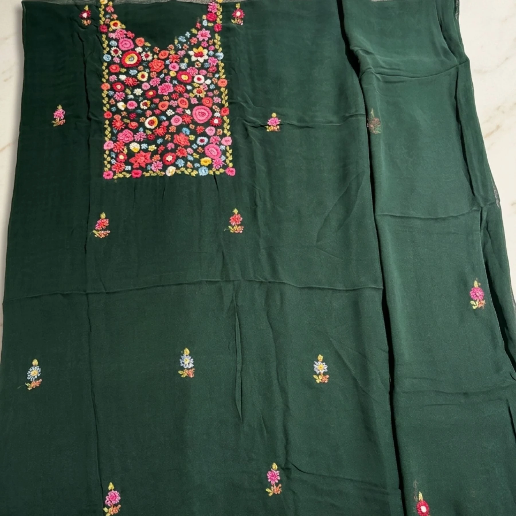 Bottle green georgette unstitched suit with thread work on neck by Kharatis