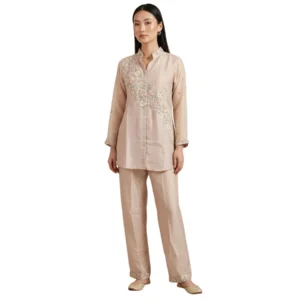 Woman wearing blush pink organza embroidered co-ord set with pearl work