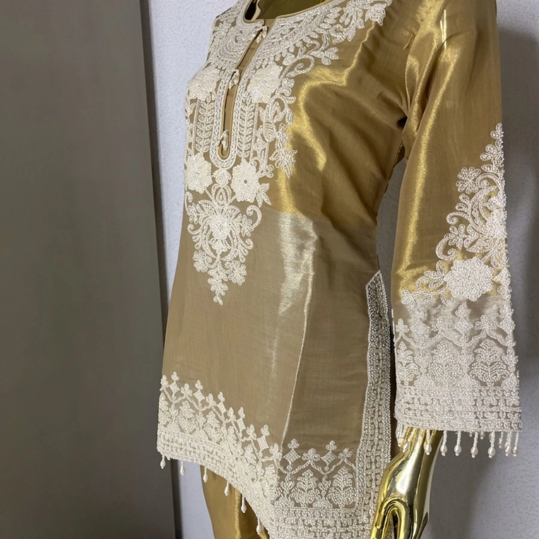 Woman wearing gold shimmer pearl work bell bottom co-ord set with dupatta