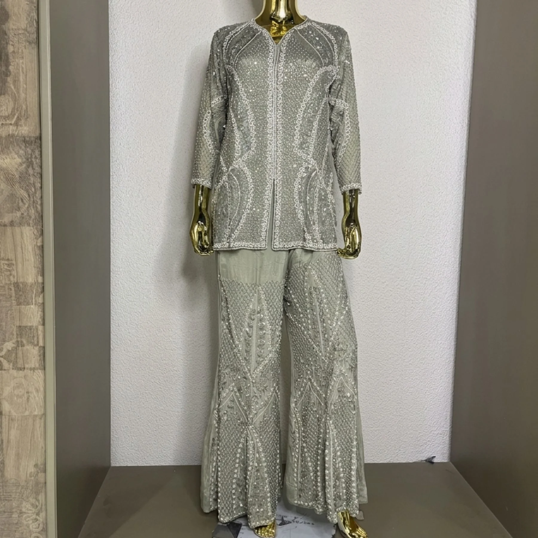 Woman wearing sage green organza pearl work co-ord set with dupatta