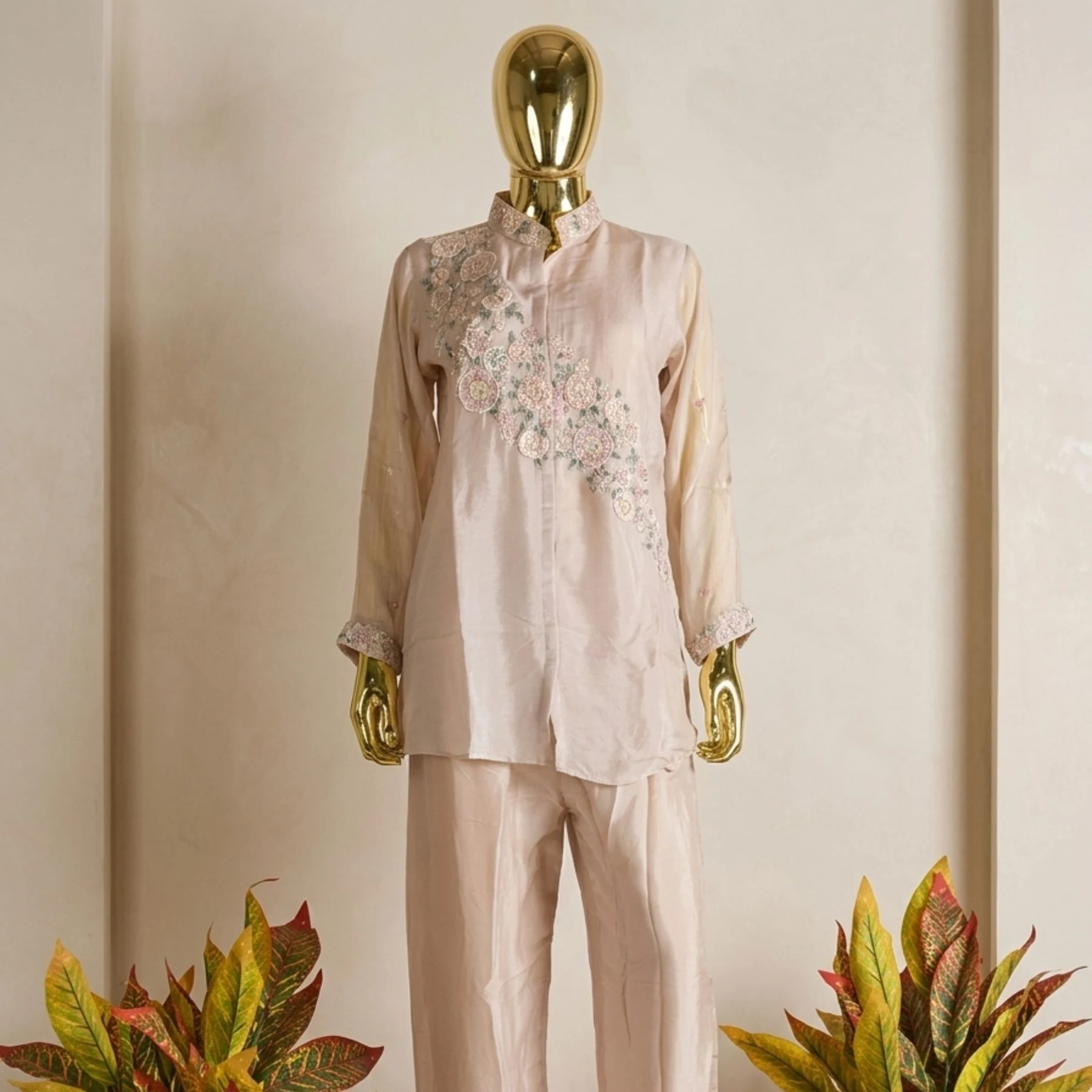 Woman wearing blush pink organza embroidered co-ord set with pearl work
