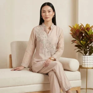 Woman wearing blush pink organza embroidered co-ord set with pearl work
