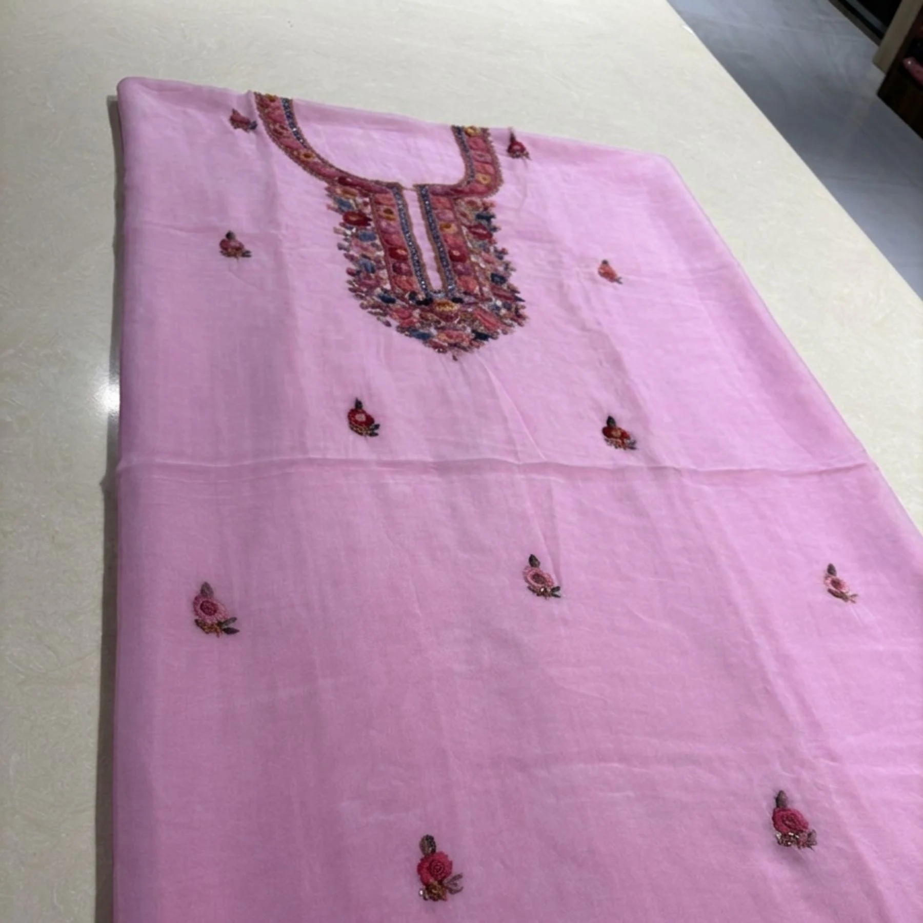 Pink georgette unstitched suit with thread knot work on neck by Kharatis