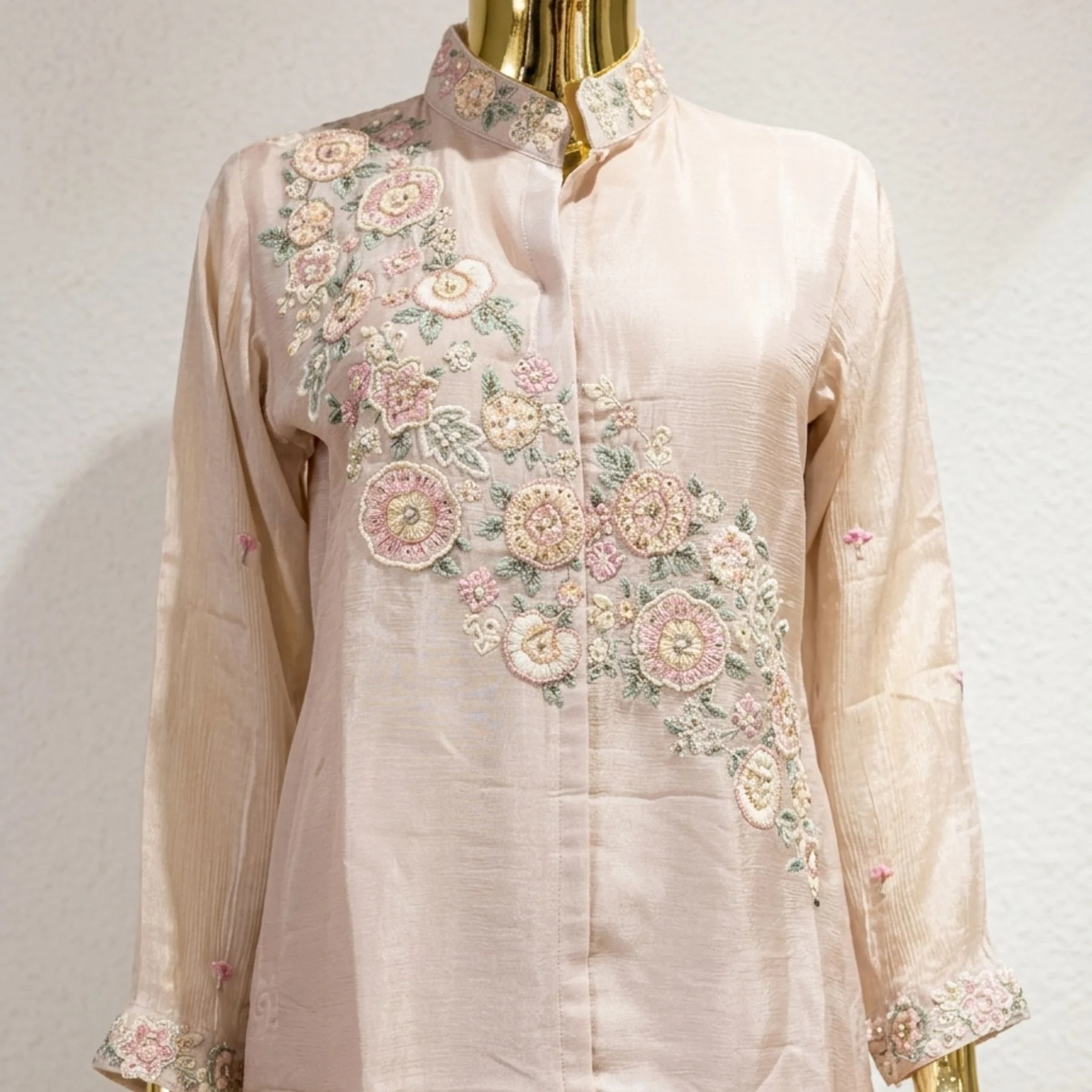 Woman wearing blush pink organza embroidered co-ord set with pearl work
