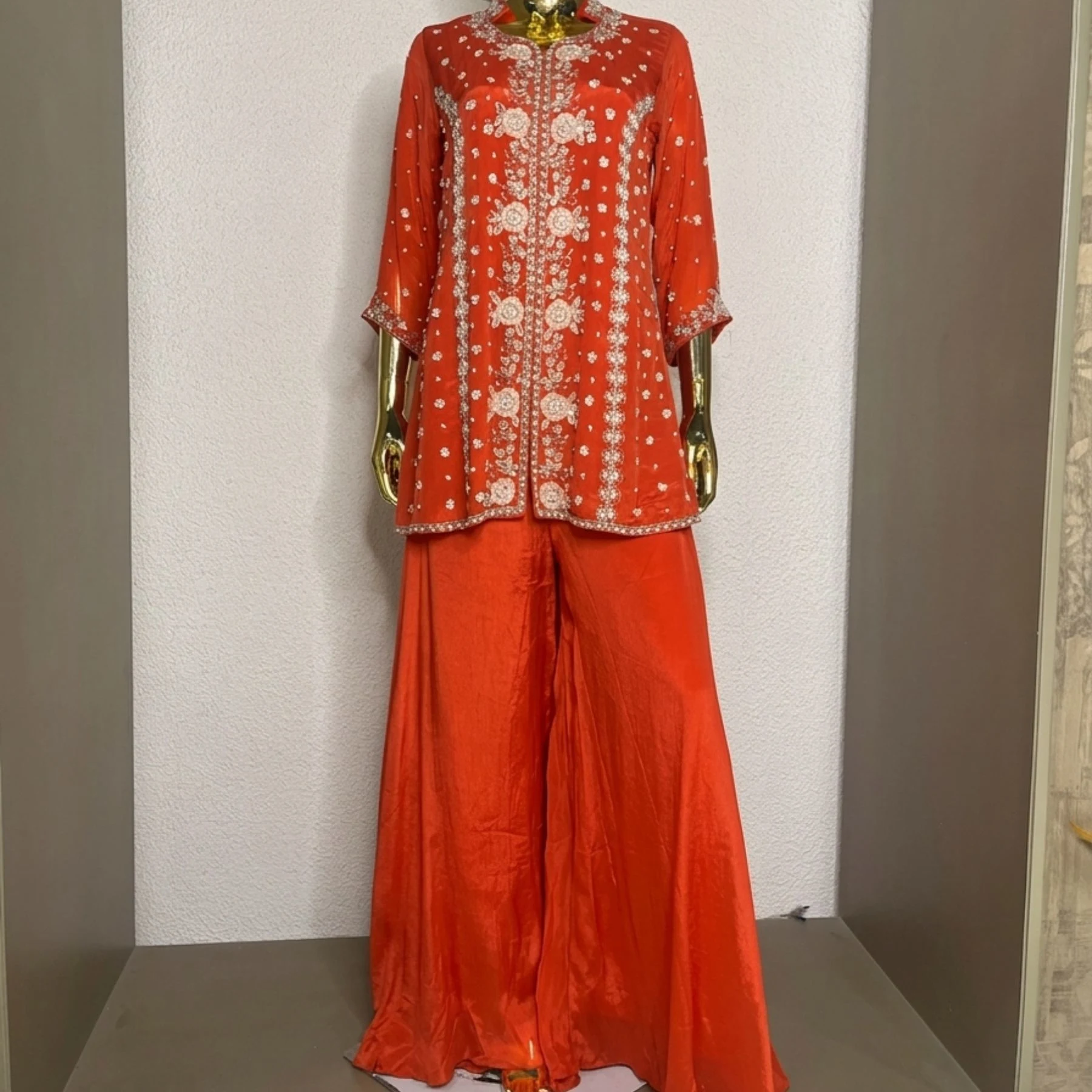 Woman wearing orange chinnon pearl work embroidered co-ord set