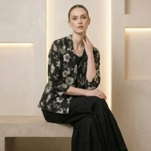 Woman wearing black printed chinnon garara co-ord set with pearl work jacket