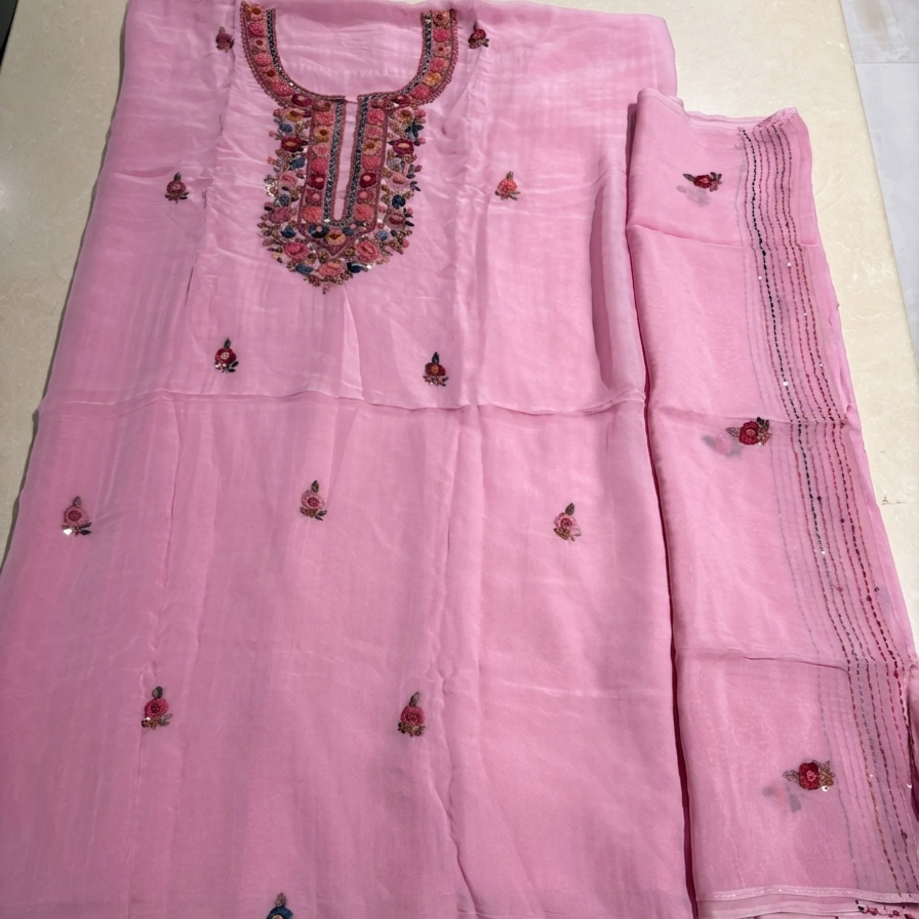 Pink georgette unstitched suit with thread knot work on neck by Kharatis