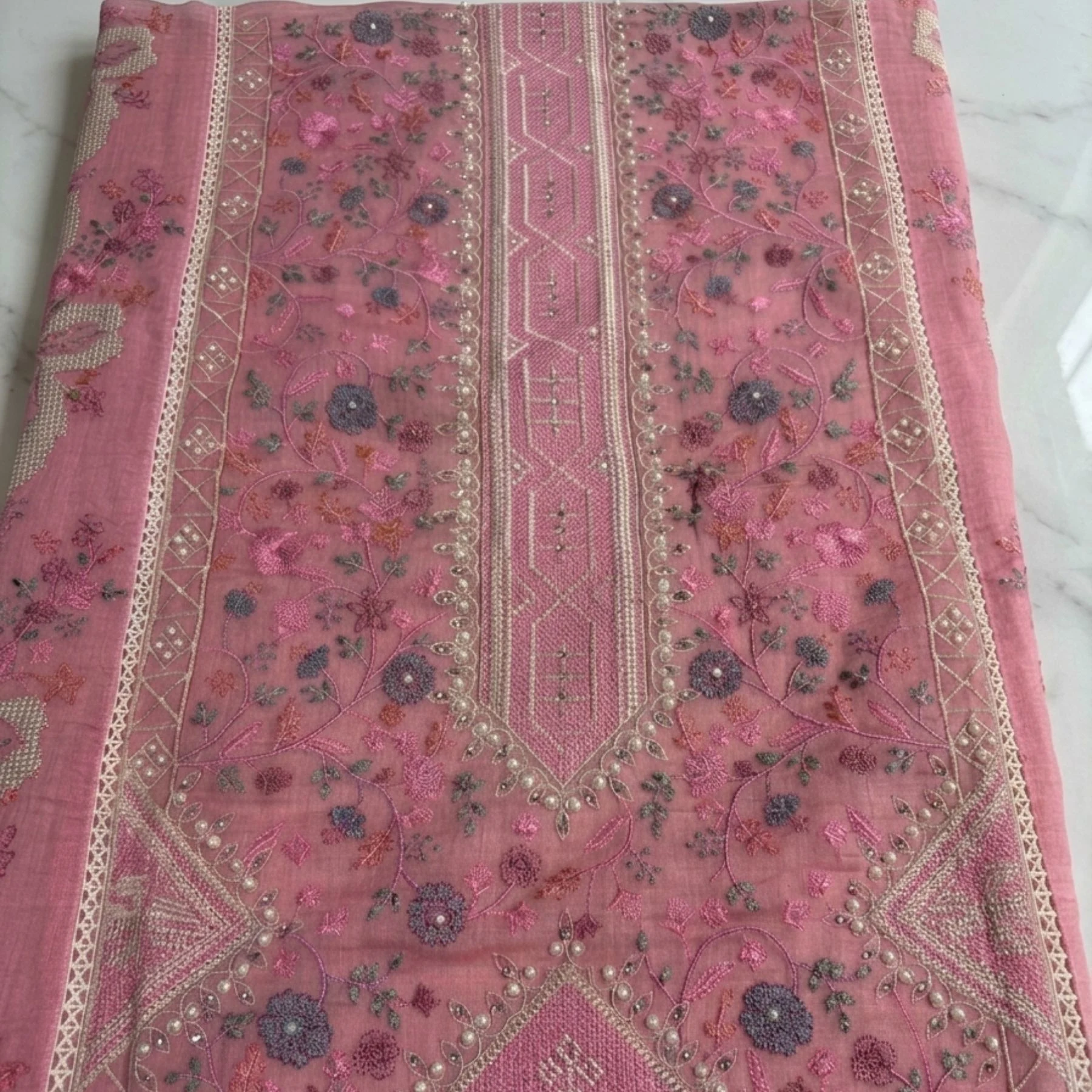 Soft muted dusty pink mul cotton unstitched suit with delicate floral motifs by Kharatis