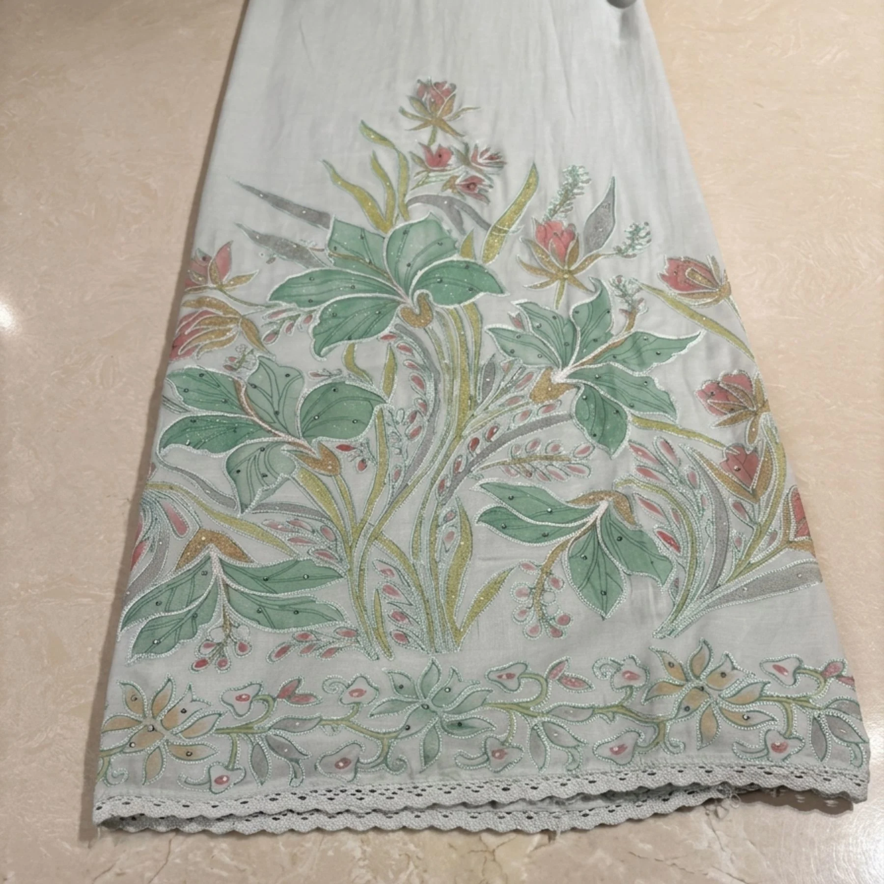 Powder mint green unstitched suit with delicate floral embroidery by Kharatis