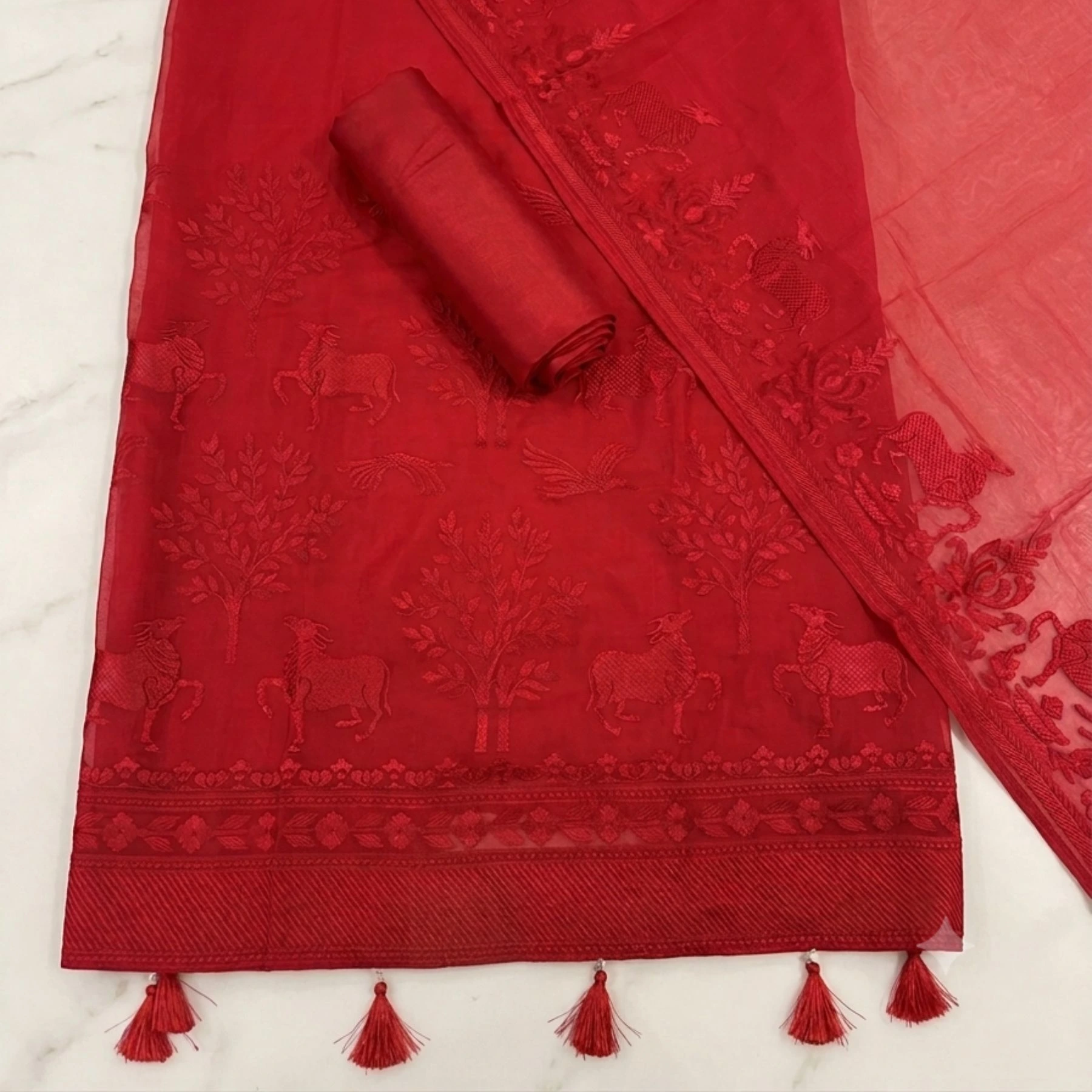 Rich vibrant red unstitched suit with structured embroidery on neck and dupatta by Kharatis