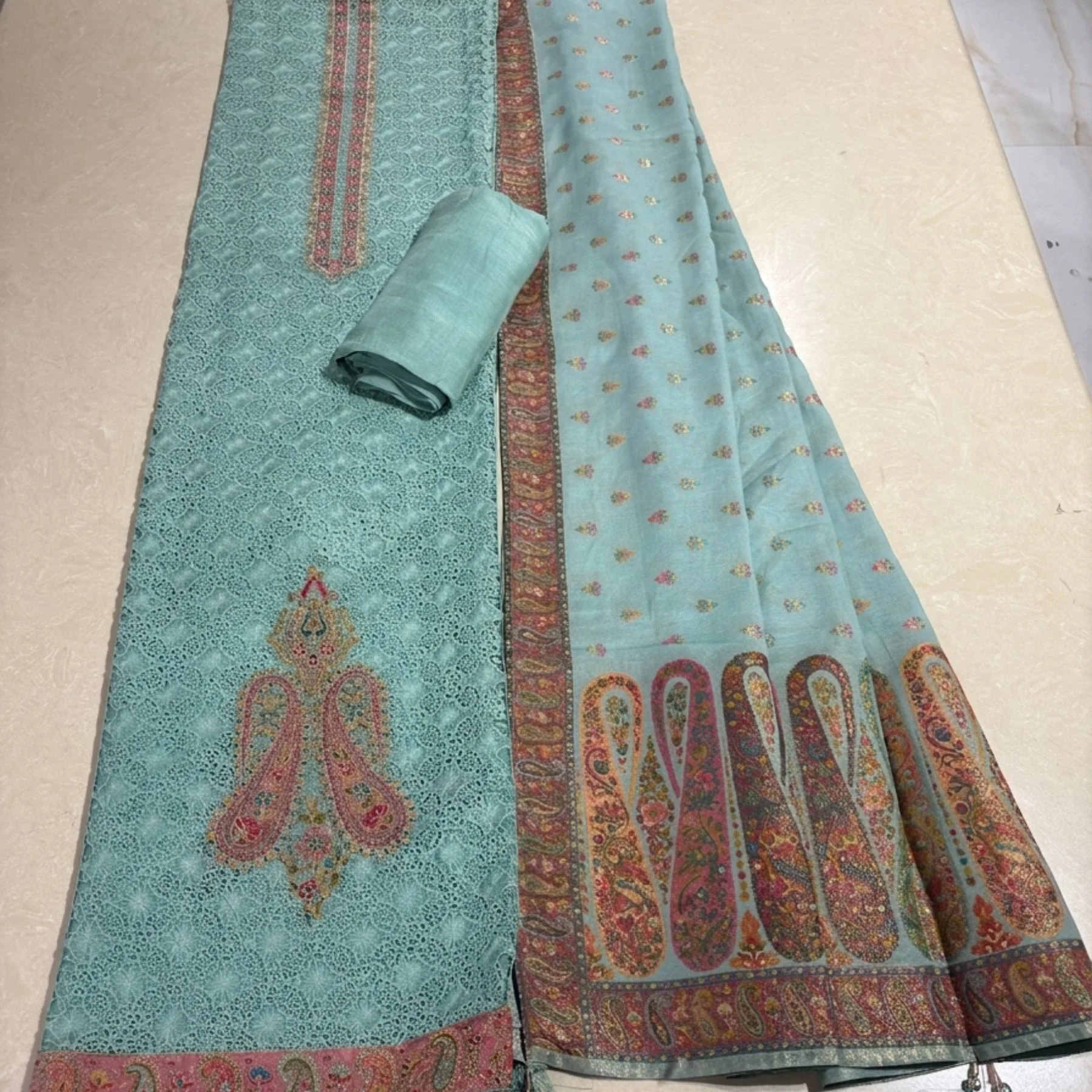Mint turquoise unstitched suit with jaal embroidery and thread work pattern by Kharatis