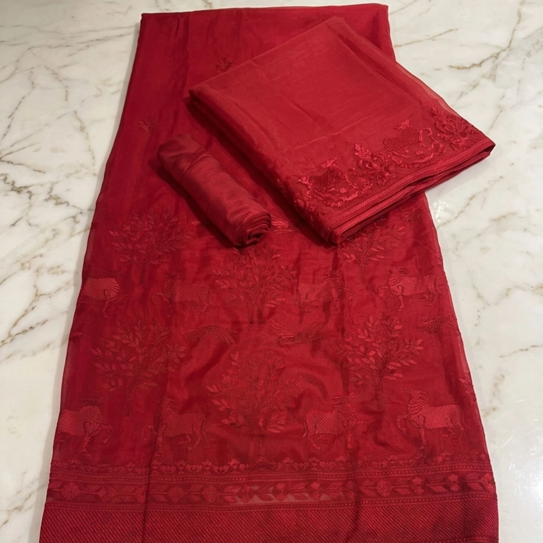 Rich vibrant red unstitched suit with structured embroidery on neck and dupatta by Kharatis