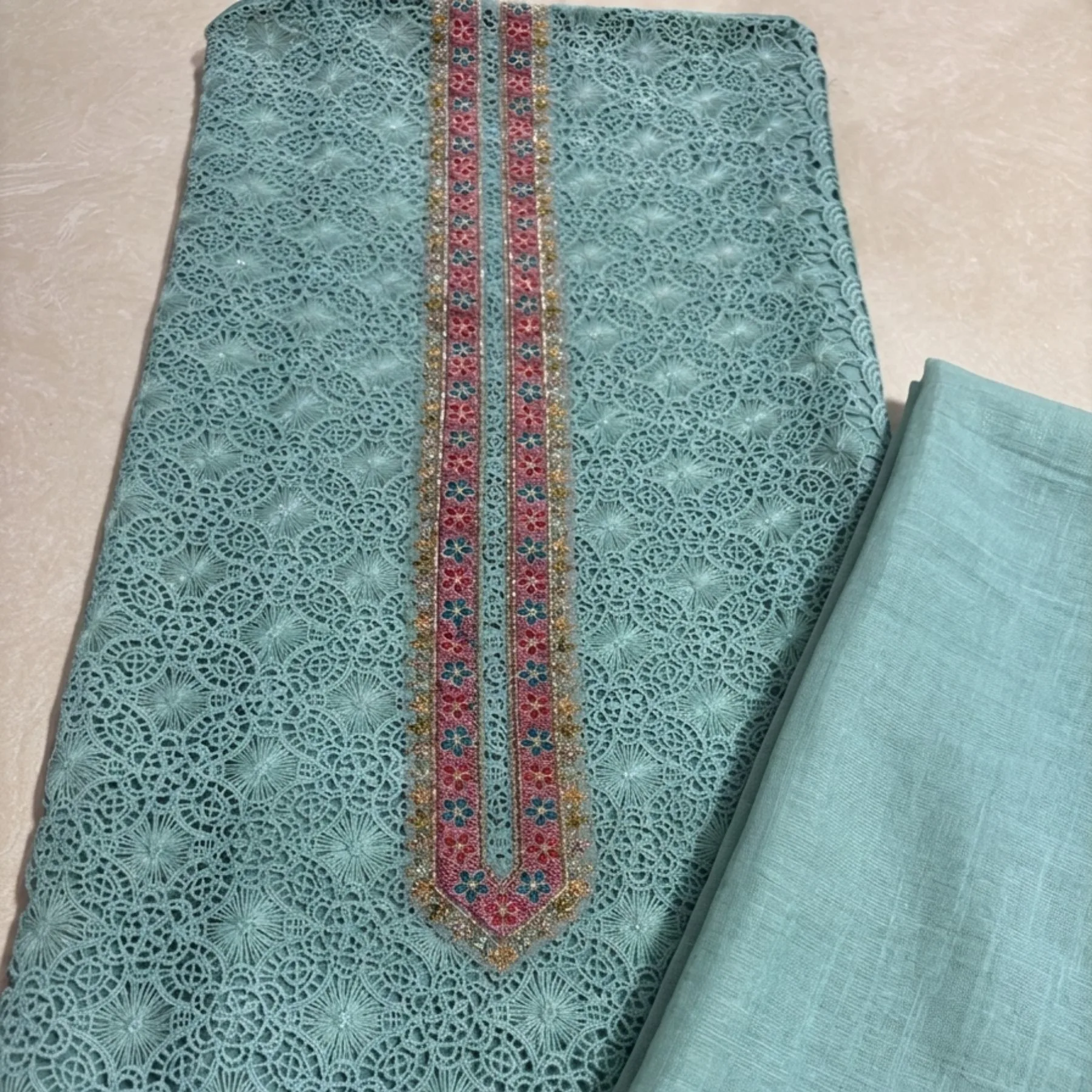 Mint turquoise unstitched suit with jaal embroidery and thread work pattern by Kharatis