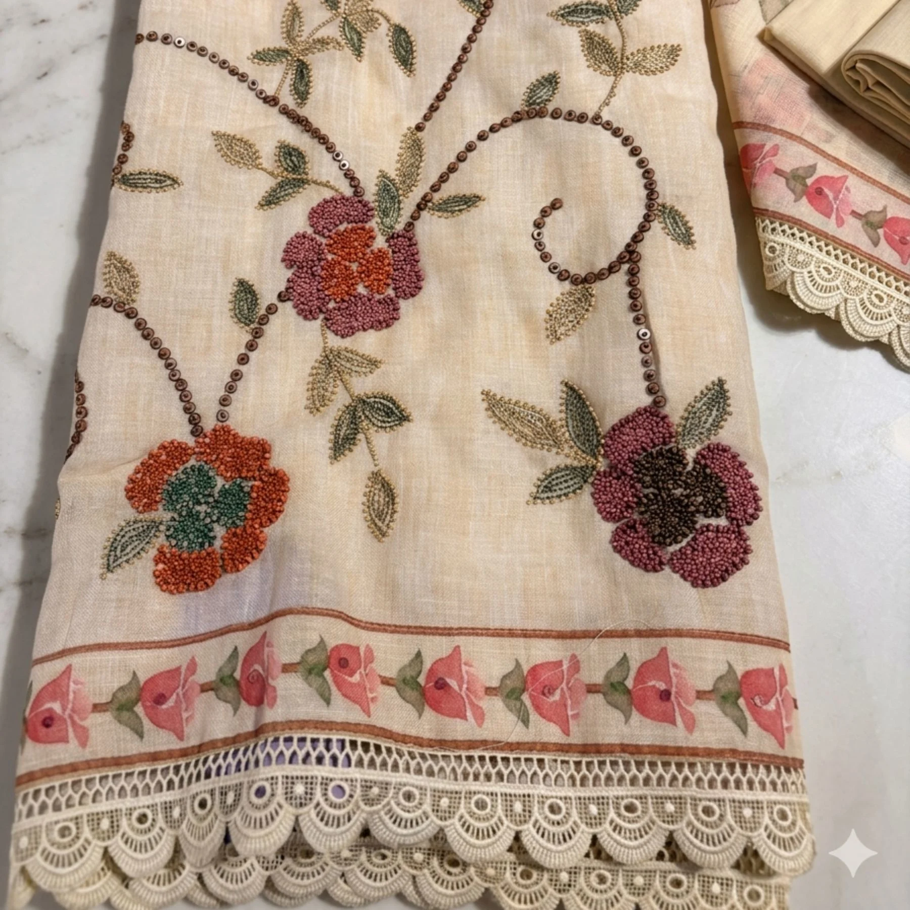 Light cream premium mul cotton unstitched suit with stylized floral sequin work by Kharatis