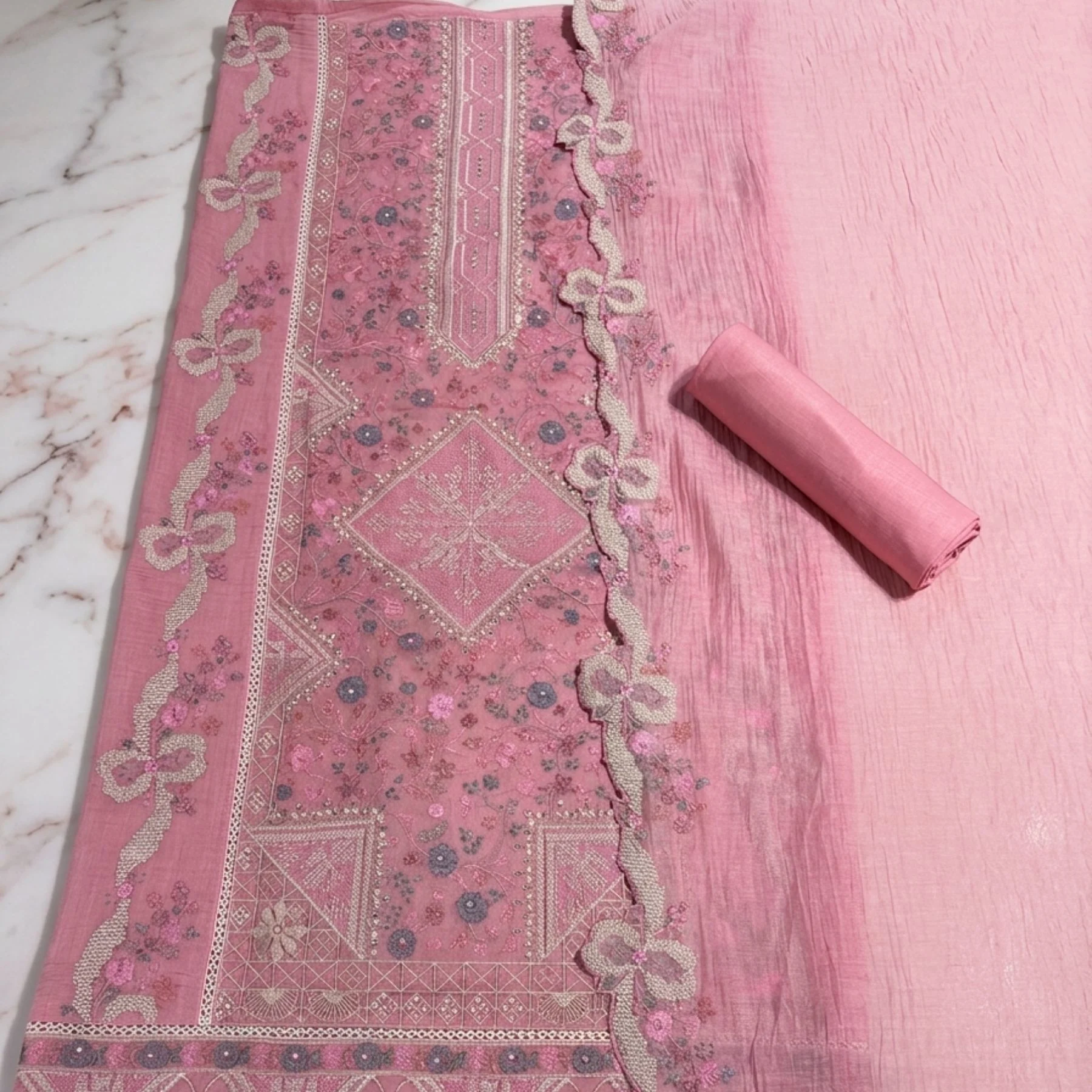 Soft muted dusty pink mul cotton unstitched suit with delicate floral motifs by Kharatis