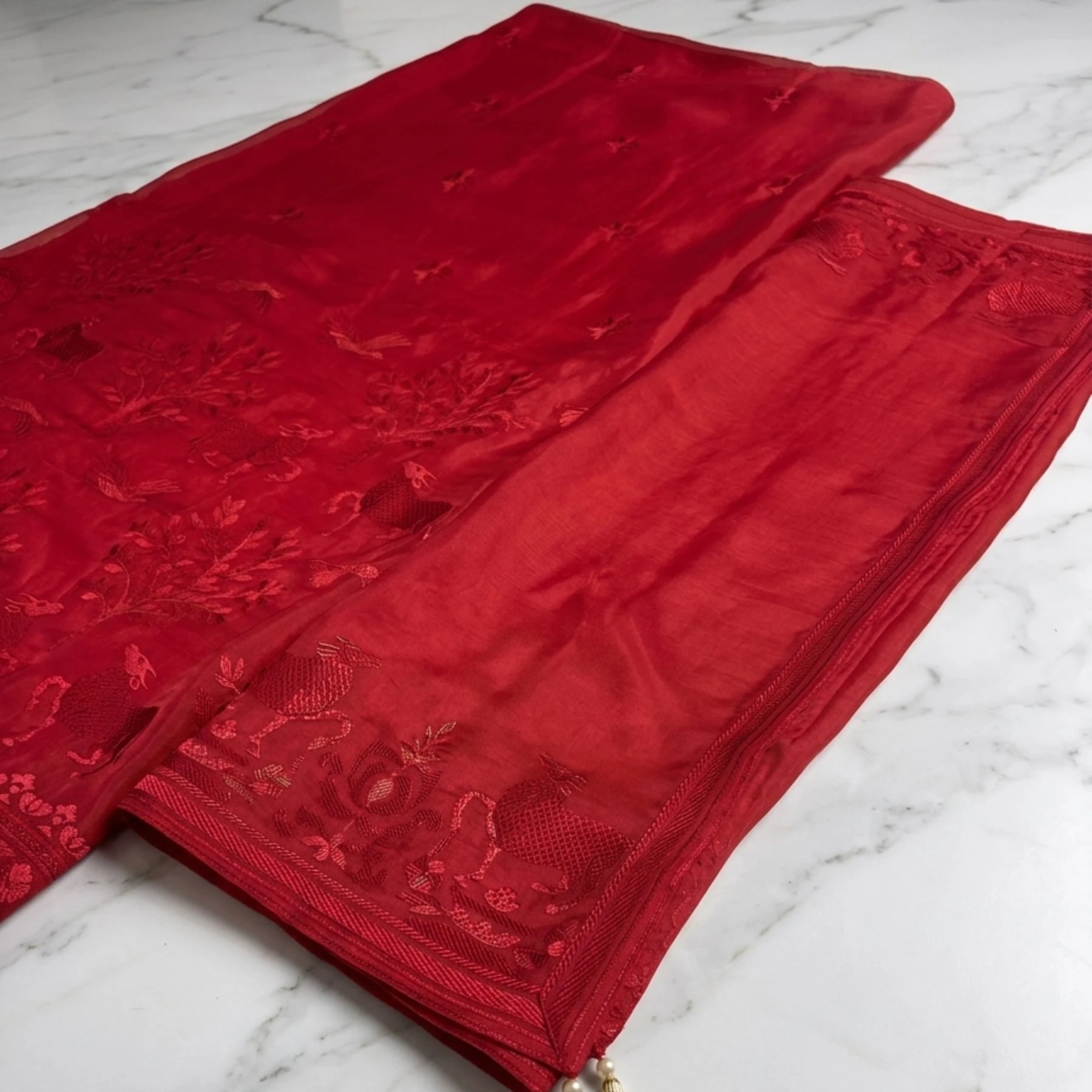 Rich vibrant red unstitched suit with structured embroidery on neck and dupatta by Kharatis