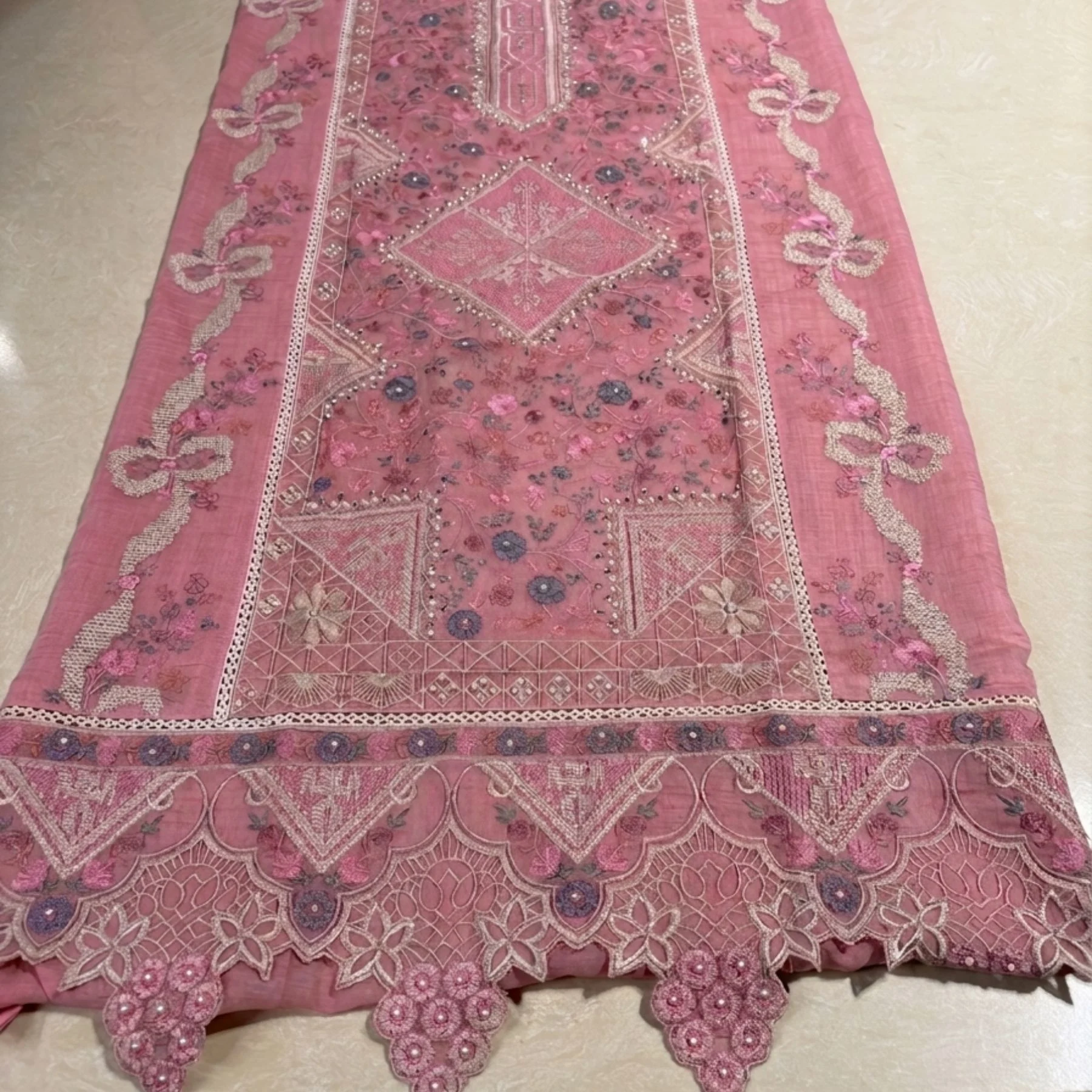 Soft muted dusty pink mul cotton unstitched suit with delicate floral motifs by Kharatis