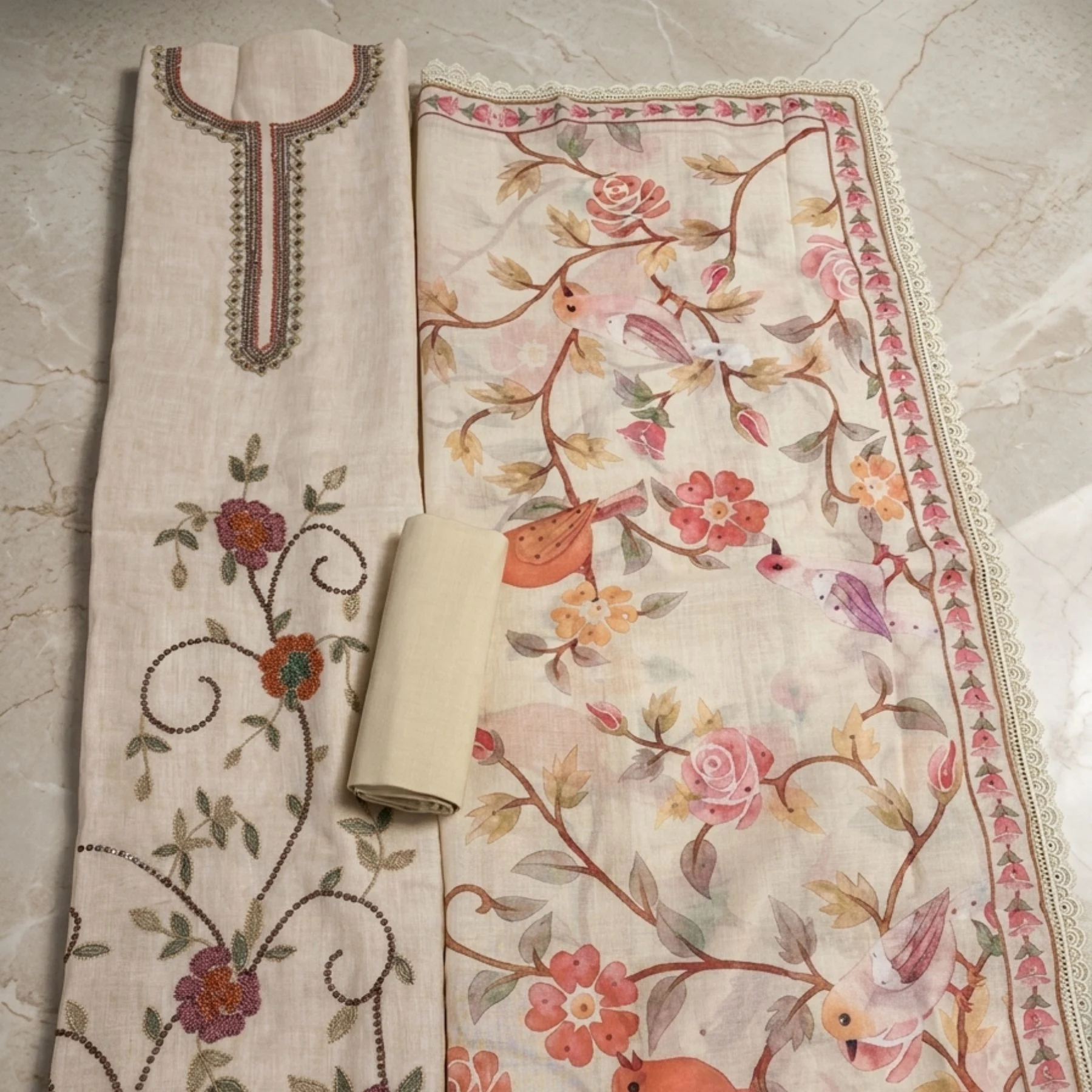 Shop light cream premium mul cotton unstitched suit with stylized floral sequin work. Elegant and comfortable ethnic wear for women at Kharatis.